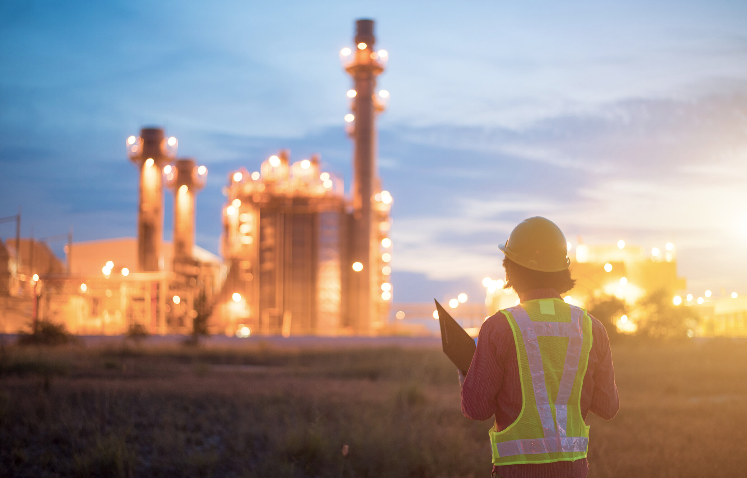 Oil refinery plant at sunrise with sky background